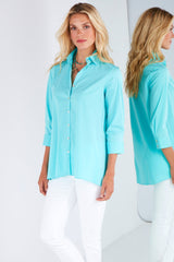 A fashion model wearing the Finley trapeze top, a black long-sleeve button-down blouse with a relaxed fit and an A-line shape.