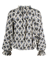 A rear view of the Finley Brette blouson, a ruffled long sleeve blouse with a v-neckline and a vintage medallion print.