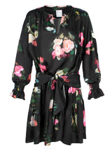 A front view of the Finley Coco dress, a midi peasant dress with a long sleeves, a front tie and a Dutch floral pattern.