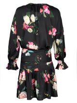 A rear view of the Finley Coco dress, a midi peasant dress with a long sleeves, a front tie and a Dutch floral pattern.