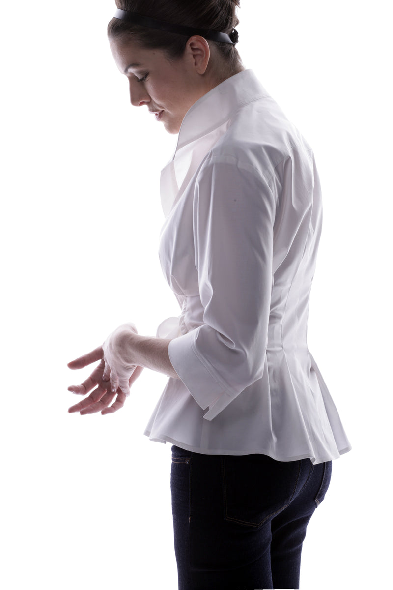 A clothing model wearing the Finley Rocky blouse, a white 3/4 sleeve shirt with a tie front and a tailored fit.