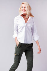 A fashion model wearing the Finley Alex blouse, a black button-down poplin shirt with a barrel cuff and a relaxed fit.
