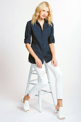 A blonde supermodel wearing the Finley Joey designer blouse, a casual button down navy designer shirt with a vintage tailored fit.