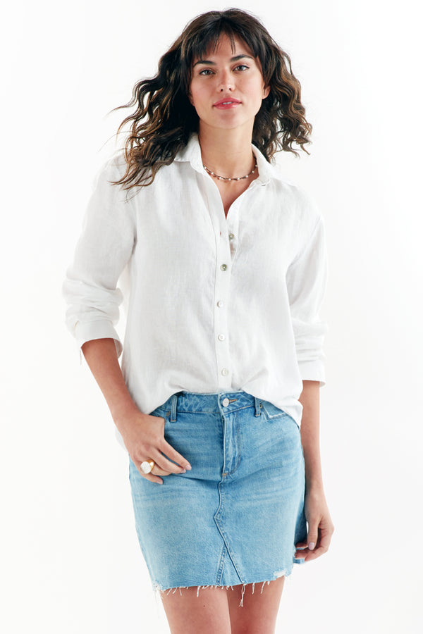 A model wearing the Finley Monica shirt, a white washed linen button-down blouse with long sleeves and a relaxed fit.