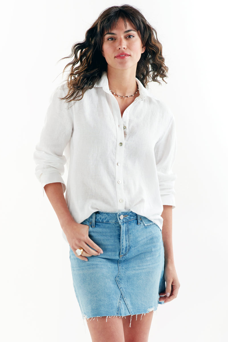 A model wearing the Finley Monica shirt, a white washed linen button-down blouse with long sleeves and a relaxed fit.
