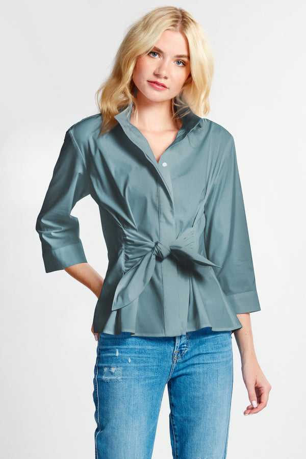 The Finley Rocky blouse, a pale blue button down weathercloth blouse with a fitted shape, a tie front, and stand collar.