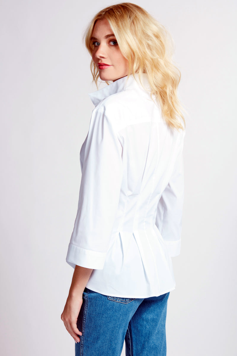 A blonde supermodel wearing the Finley Rocky blouse, a white 3/4 sleeve blouse with a tie front and a tailored fit.