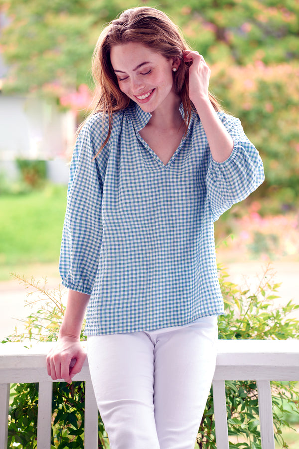 The Finley Floaty top, a green & blue seersucker print pullover blouse with short puff sleeves and a stand collar.