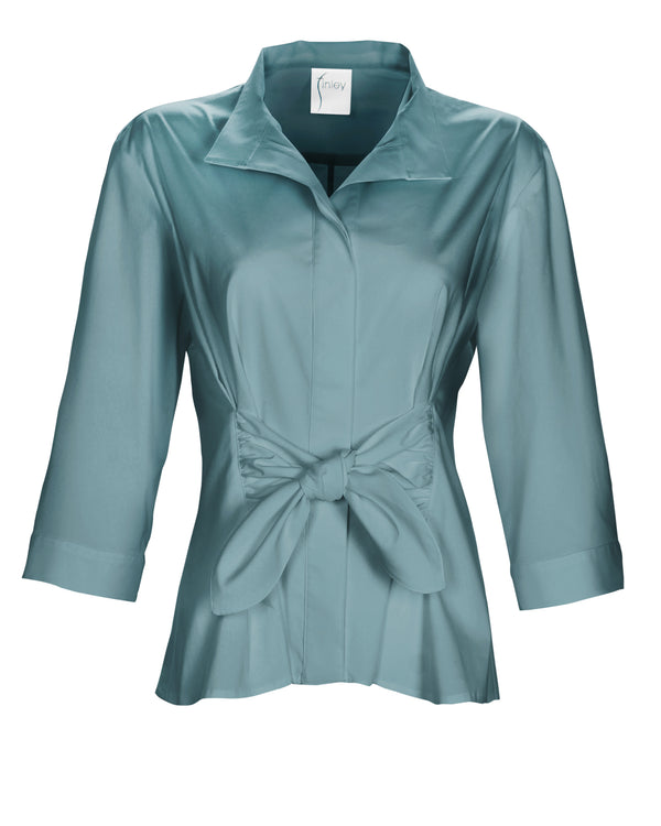 The Finley Rocky blouse, a pale blue button down weathercloth blouse with a fitted shape, a tie front, and stand collar.
