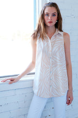 A model wearing the Finley Shelly blouse, a button-down sleeveless shirt dress with a brown and white zebra print.