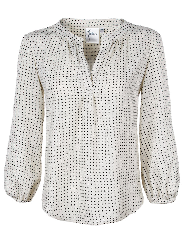A front view of the Finley Stephanie top, a white popover blouse with a relaxed fit, long sleeves, and a black dot pattern.