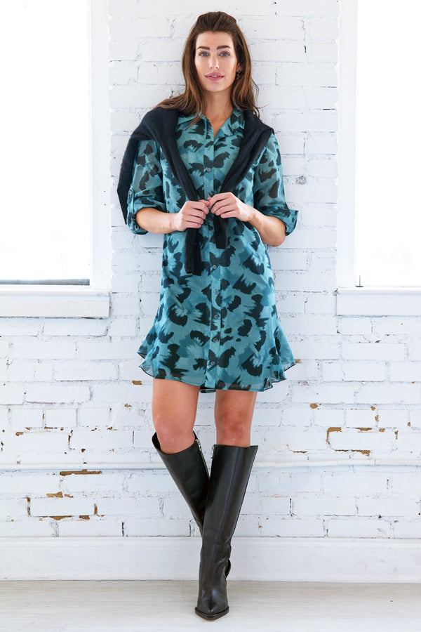 The Finley Agatha dress, a cotton voile button down midi shirt dress with a ruffle hem and a teal and black floral pattern.
