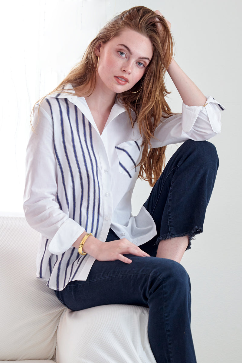 The Finley Alex blouse, a button down women's shirt with embroidered blue and white stripes and a semi-fitted shape. 