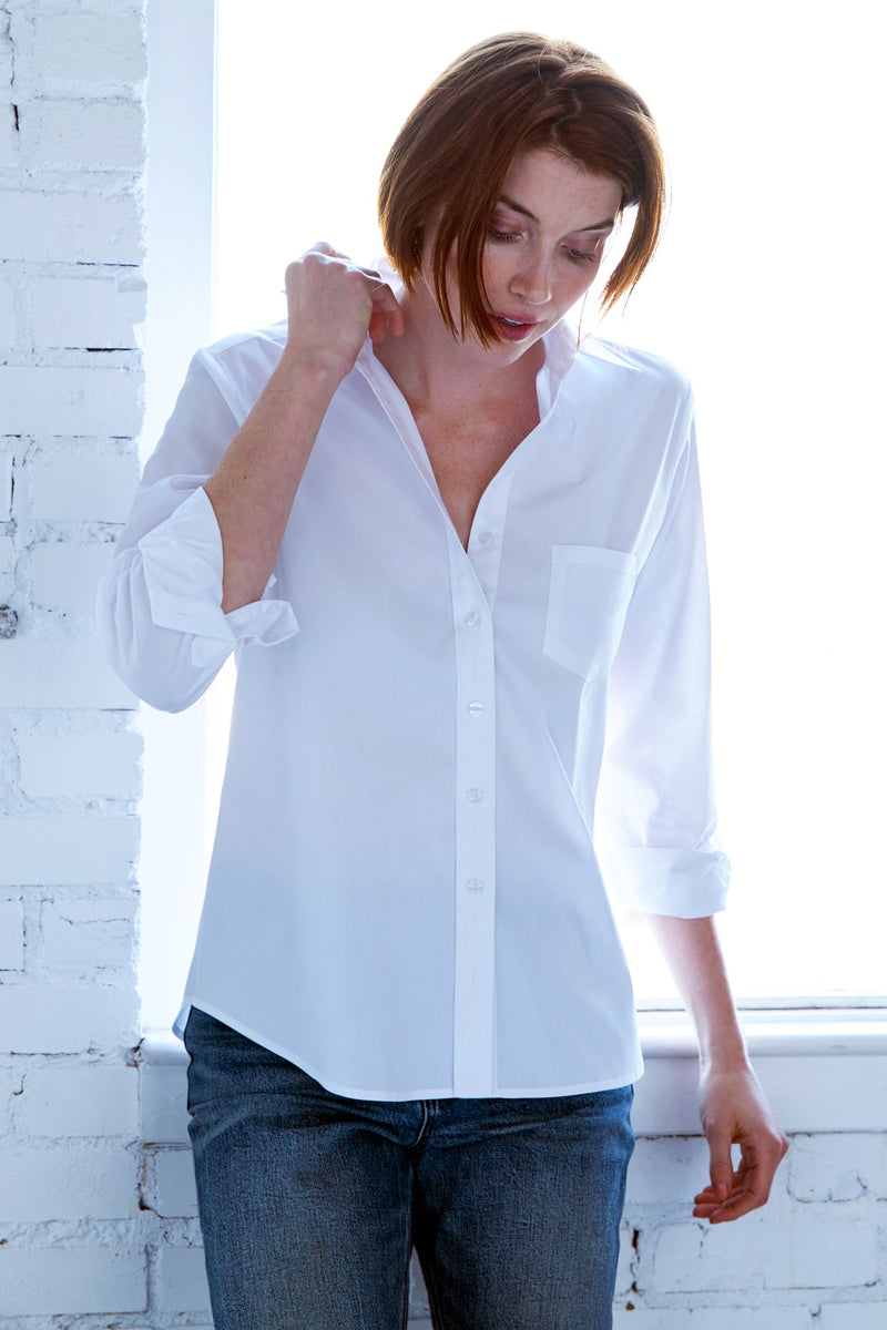 A fashion model wearing the Finley Alex blouse, a white button-down poplin shirt with a barrel cuff and a relaxed fit.