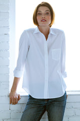 A fashion model wearing the Finley Alex blouse, a white button-down poplin shirt with a barrel cuff and a relaxed fit.
