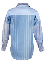 The Finley boyfriend shirt, a color-blocked blue and white striped shirt with an asymmetric pocket.