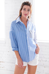 A model wearing the Finley boyfriend shirt, a color-blocked blue and white striped shirt with an asymmetric pocket.