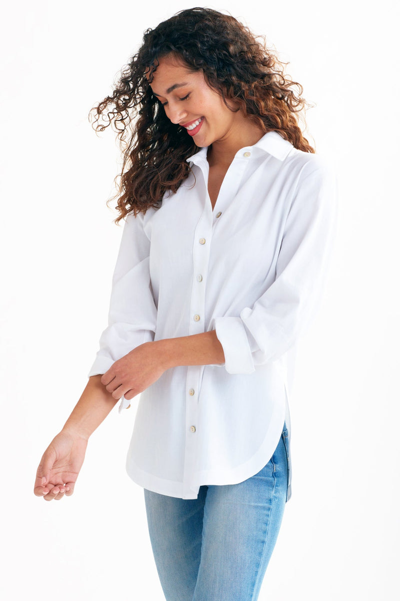 A fashion model wearing the Finley boyfriend shirt, a white cotton voile button-down blouse with a relaxed fit.