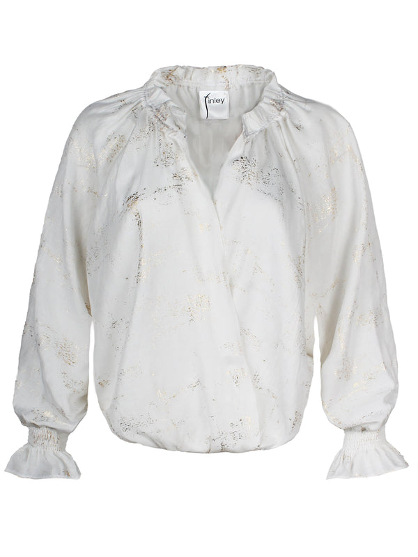 A front view of the Finley Brette blouson, a ruffle trim white blouse with a v-neckline and a metallic gold texture.