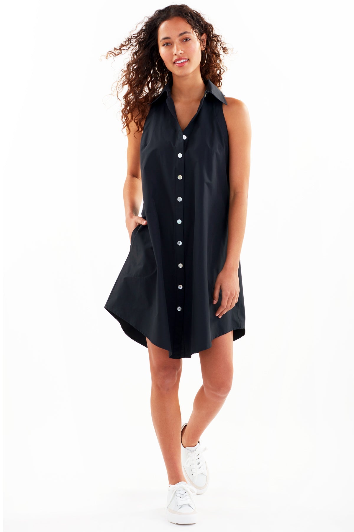 The Finley swing dress, a casual cotton button-down sleeveless black midi shirt dress.