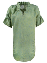 A front view of the Finley Crosby shirt dress, a washed linen dress with ruffled sleeves and collar and a sage green color.