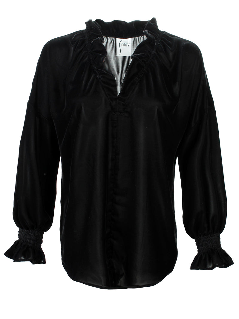 A rear view of the Finley Crosby blouse, a black whisperweight velvet top with a v-neck and ruffle detailing.