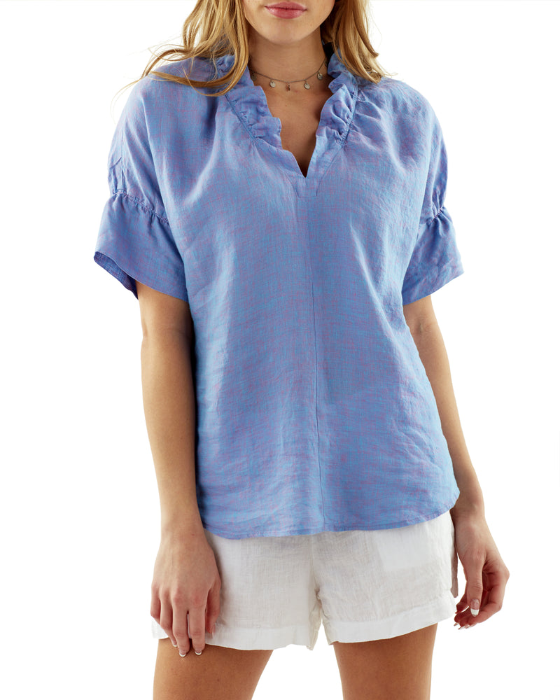 The Finley Crosby blouse, a short sleeve washed linen purple popover blouse with ruffle detail on the collar and sleeves.