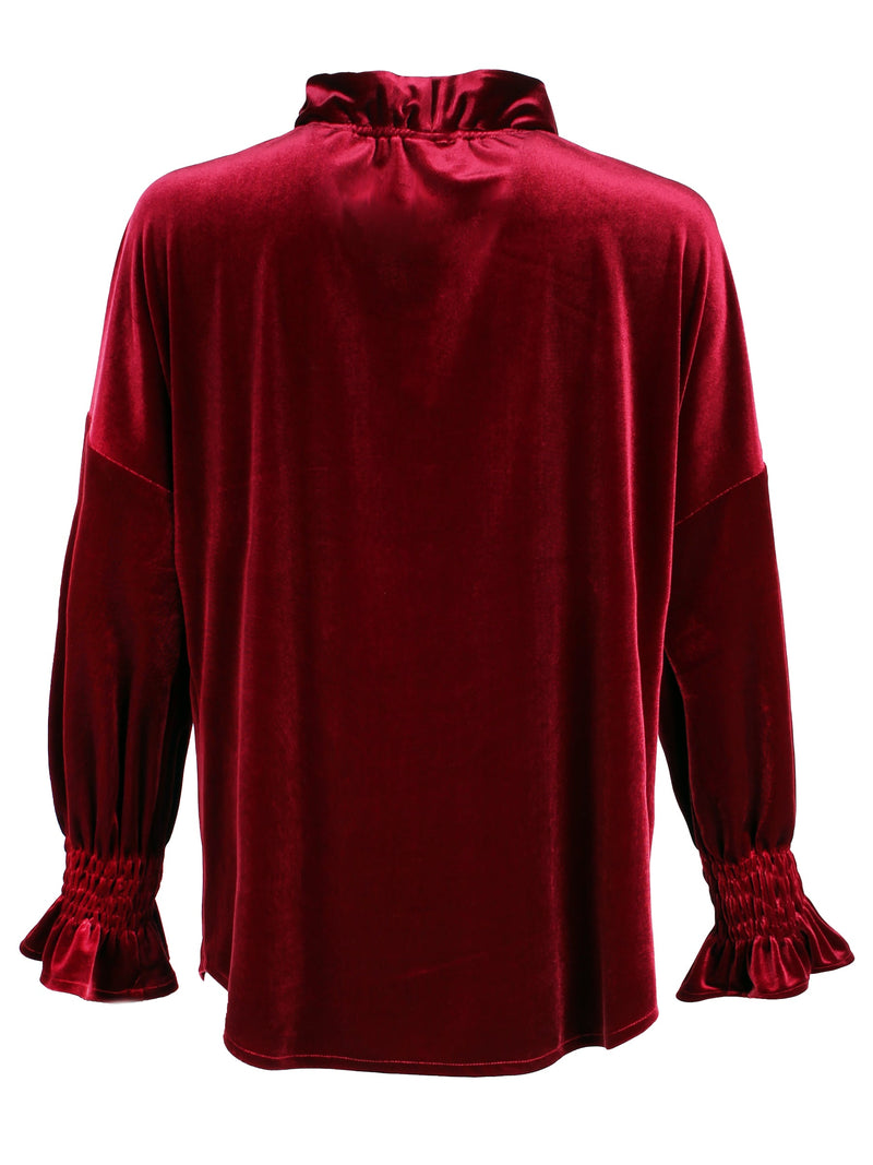 A rear view of the Finley Crosby blouse, a burgundy red whisperweight velvet top with a v-neck and ruffle detailing.