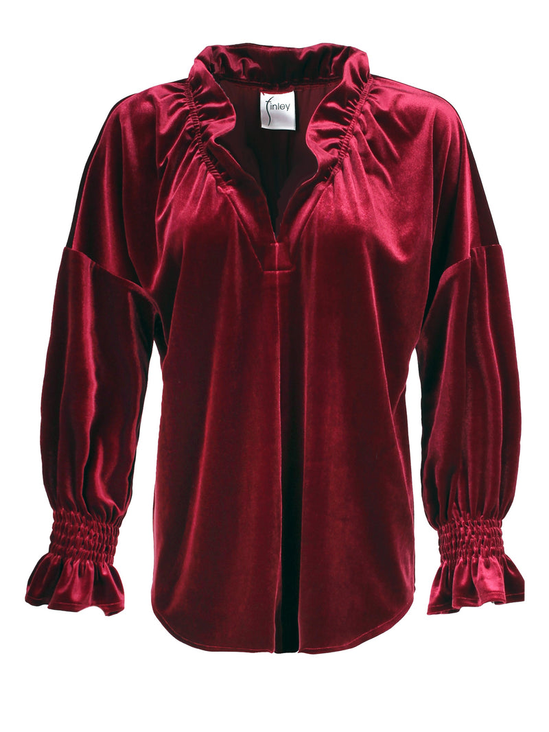 A front view of the Finley Crosby blouse, a burgundy red whisperweight velvet top with a v-neck and ruffle detailing.
