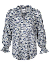 The Finley Crosby blouse, a 100% viscose button up blouse with puff sleeves, a ruffle collar, and a silver gray cloud pattern.