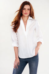 A fashion model wearing the Finley Endora shirt, a white long-sleeve blouse with a half-zip collar and a semi-tailored fit.
