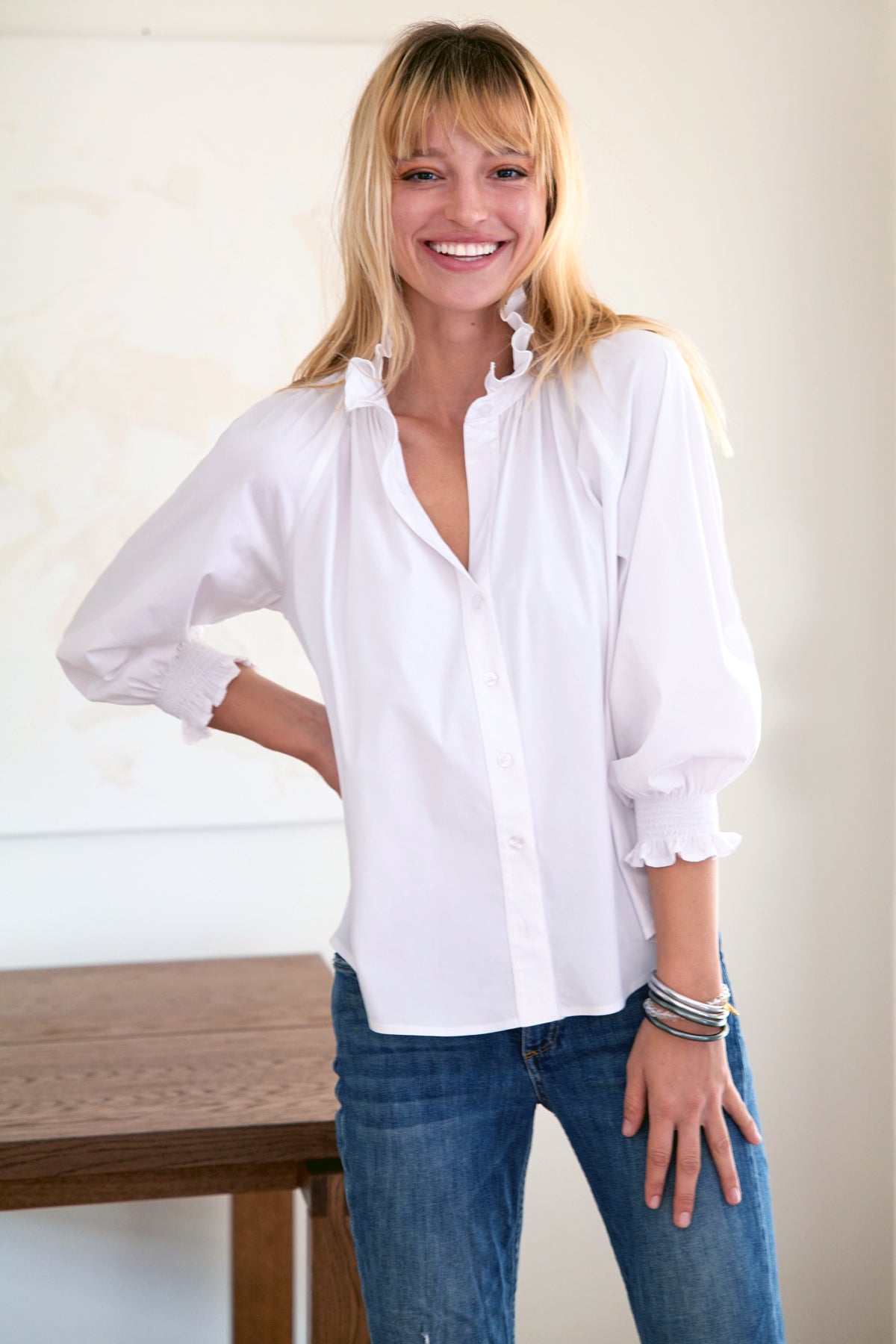 The Finley Fiona blouse, a silky poplin white button down shirt with blouson sleeves, a ruffle collar, and relaxed fit.