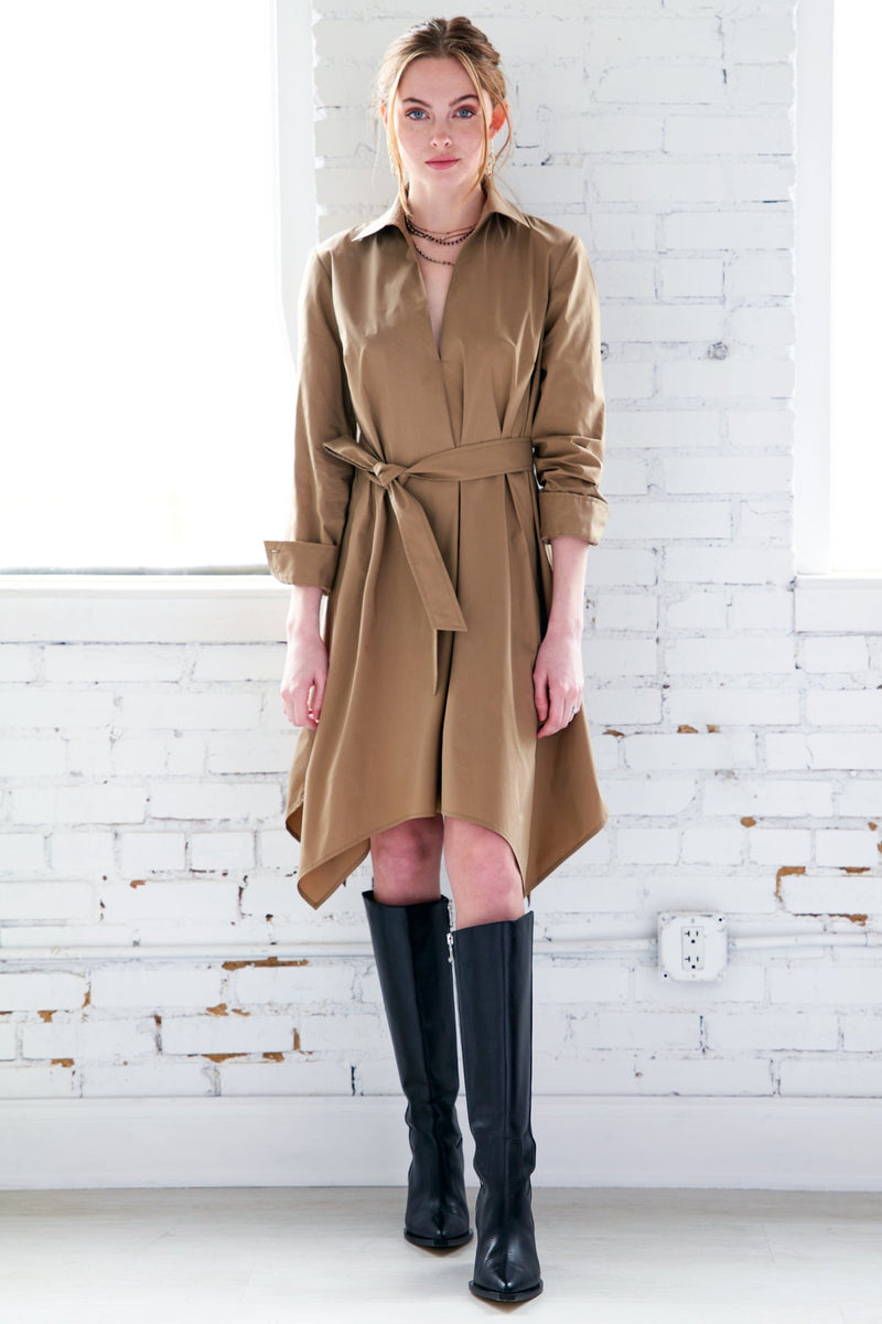 A model wearing the Finley Harrison dress, a mushroom brown long sleeve midi shirt dress with a front tie and a spread collar.