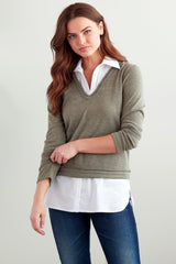 A fashion model wearing the Finley layering tank, a chambray sleeveless button-down blouse with a shirt tail hem and a knit bodice.