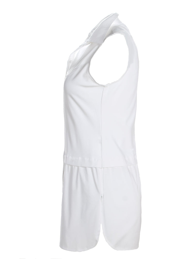 A back view of the Finley layering tank, a chambray sleeveless button-down blouse with a shirt tail hem and a knit bodice.