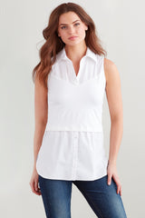 A fashion model wearing the Finley layering tank, a white sleeveless button-down blouse with a shirt-tail hem.