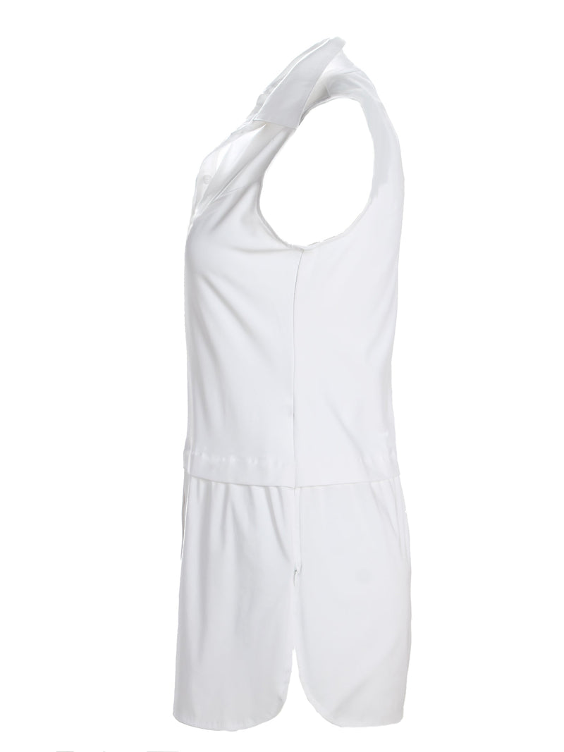 A profile view of the Finley layering tank, a white sleeveless button-down blouse with a shirt tail hem and a knit bodice.