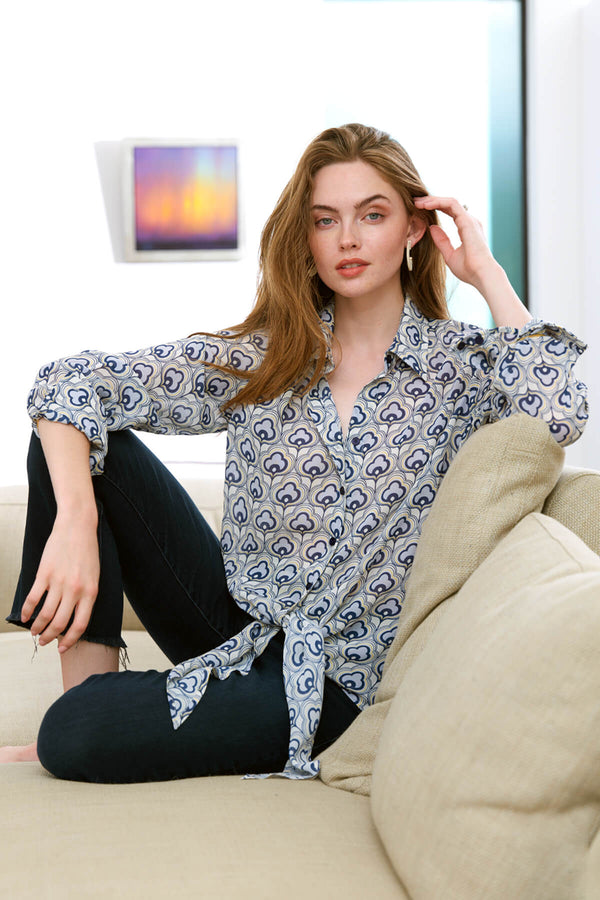 The Finley Lindy blouse, a 100% viscose button up blouse with a front tie, long sleeves, and a metallic gray cloud pattern.