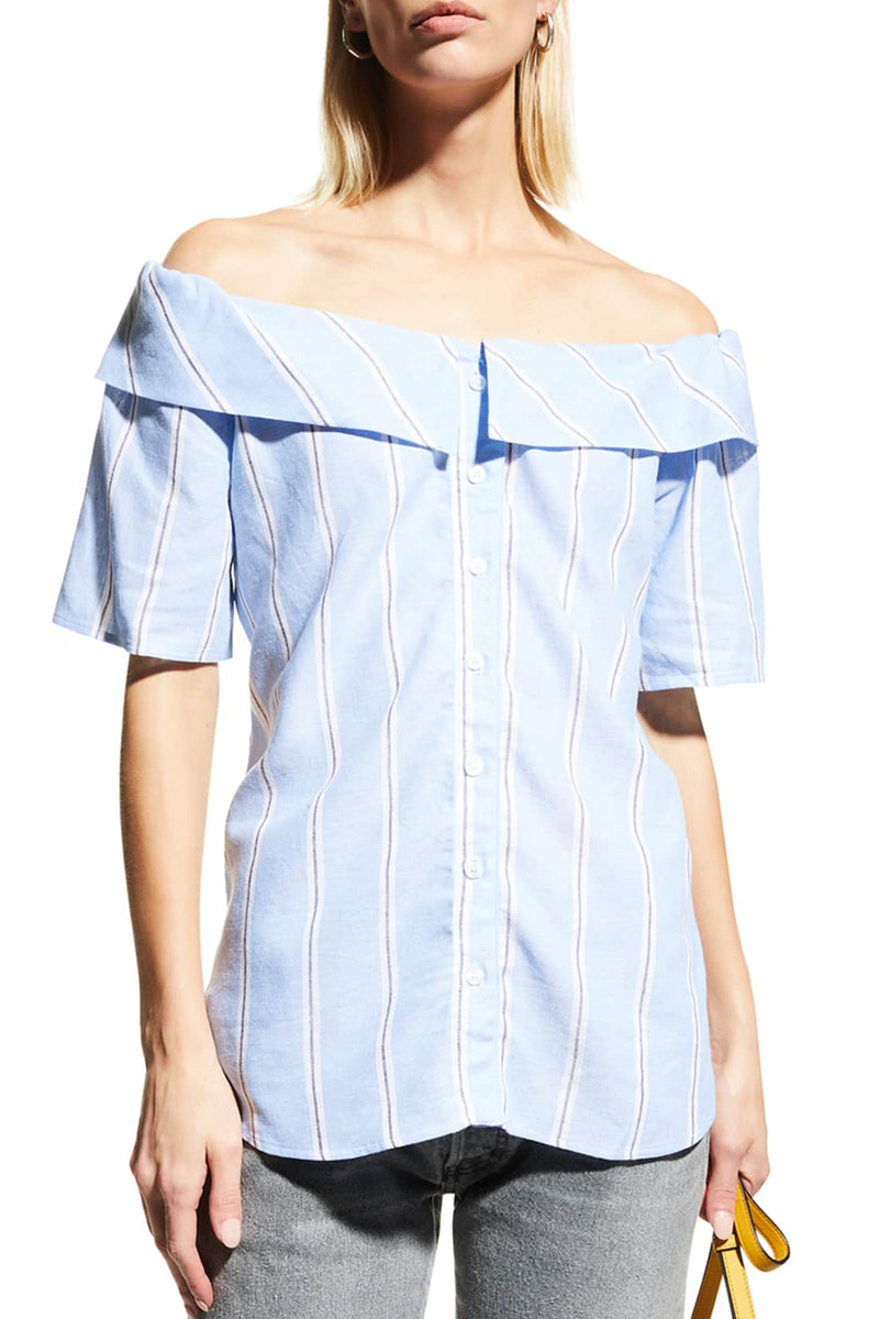 A model wearing the Finley Maddie top, an off the shoulder blue button-down blouse with short sleeves and black and white stripes.