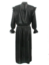 A rear view of the Finley Mary Jane Whisper dress, a black velvet dress with ruffle detailing and a semi-fitted shape.