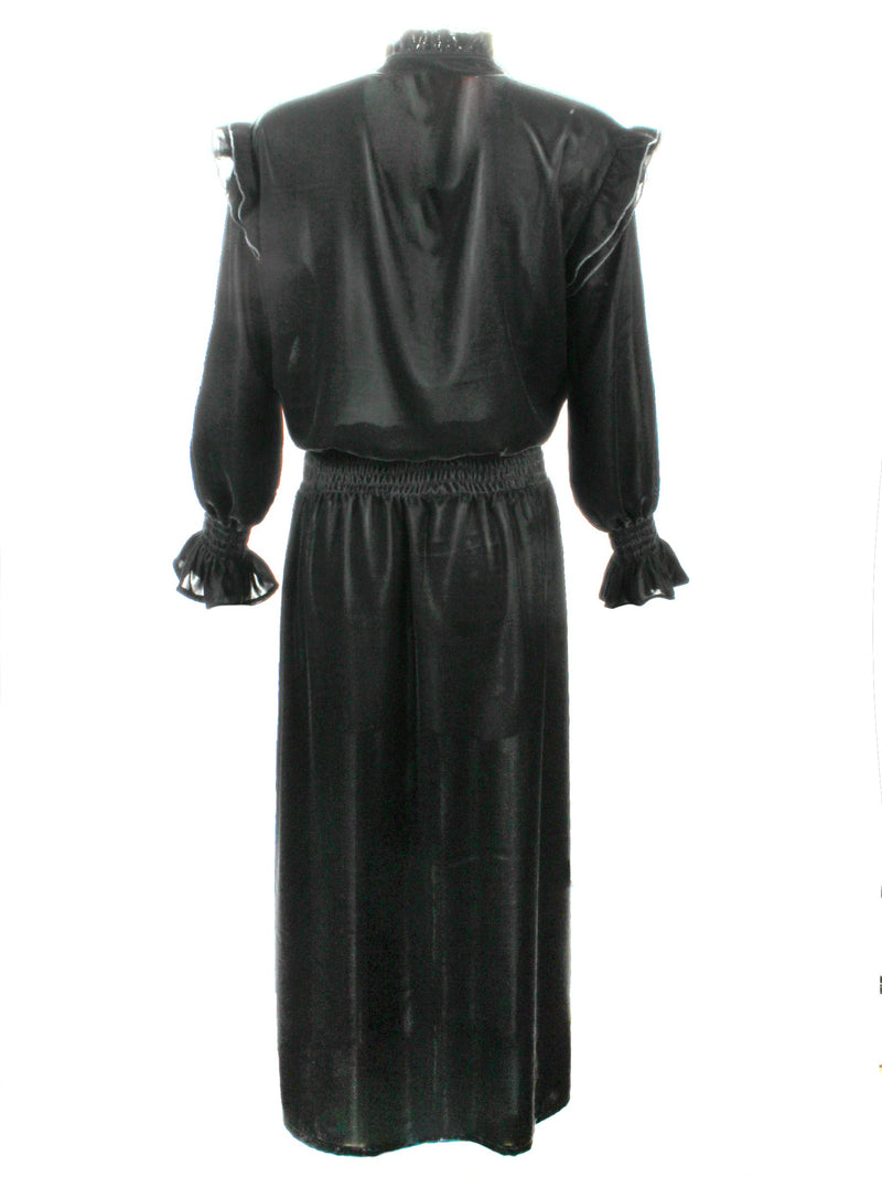 A rear view of the Finley Mary Jane Whisper dress, a black velvet dress with ruffle detailing and a semi-fitted shape.