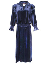 A front view of the Finley Mary Jane Whisper dress, a navy velvet dress with ruffle detailing and a semi-fitted shape.
