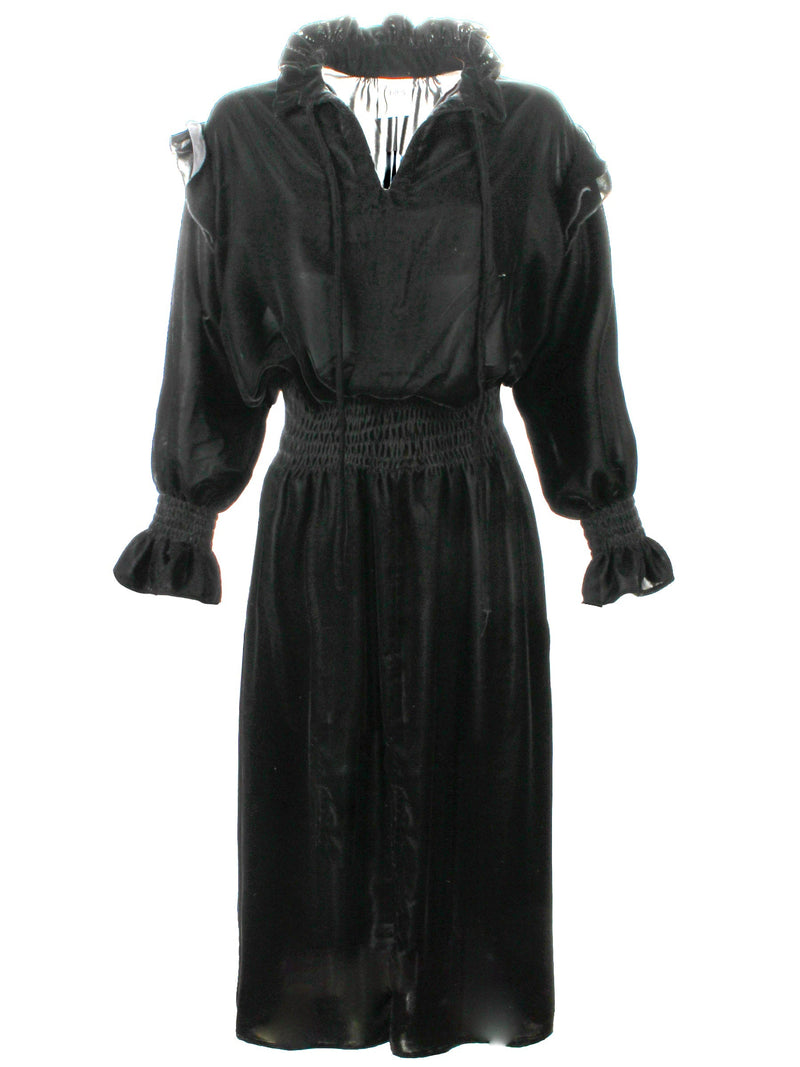 A front view of the Finley Mary Jane Whisper dress, a black velvet dress with ruffle detailing and a semi-fitted shape.
