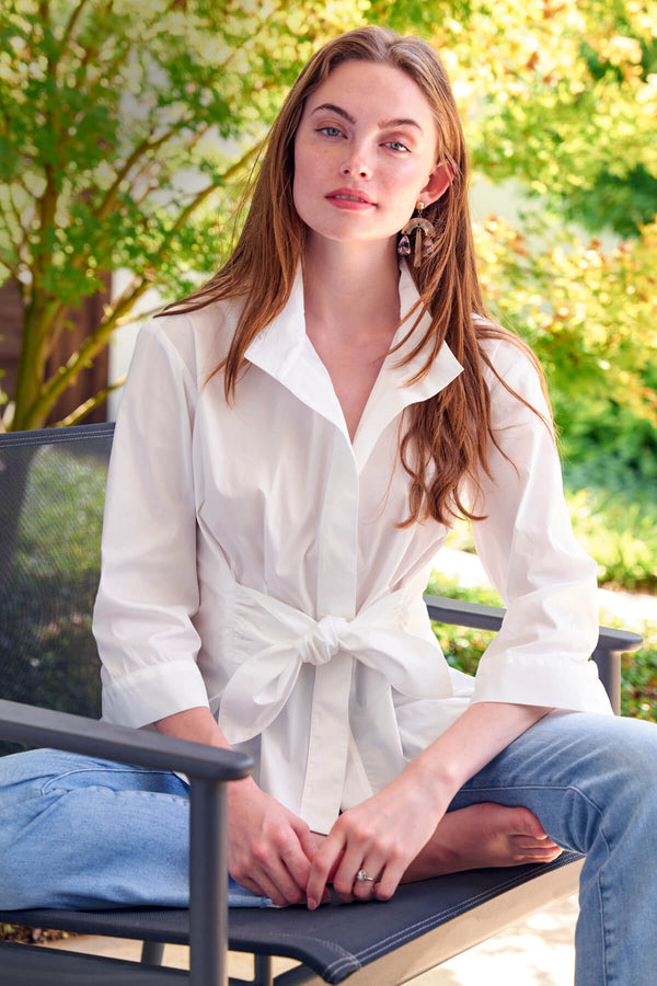 The Finley Rocky blouse, a 3/4 sleeve white weathercloth button down blouse with a front tie and a fitted shape.