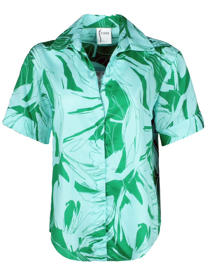 A front view of the Finley Tommi shirt, a cotton button up blouse with a boxy relaxed fit and a green and white tropical pattern.